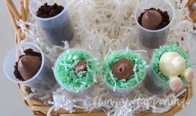 top the chocolate cake crumbs with chocolate frosting, green colored-coconut, and a white chocolate bunny. 