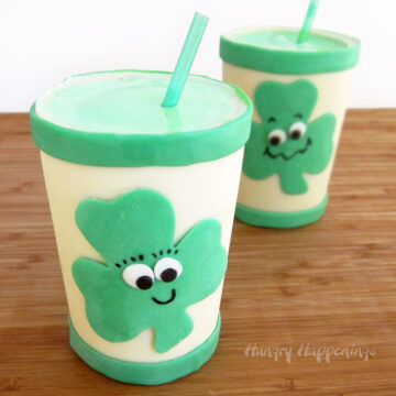 shamrock shakes served in white chocolate cups decorated with smiley face shamrocks