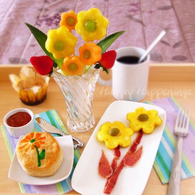 Mother's Day Breakfast in Bed with flower-shaped eggs, a fruit bouquet, and flower biscuits.