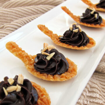 almond nougatine spoons topped with a swirl of chocolate ganche