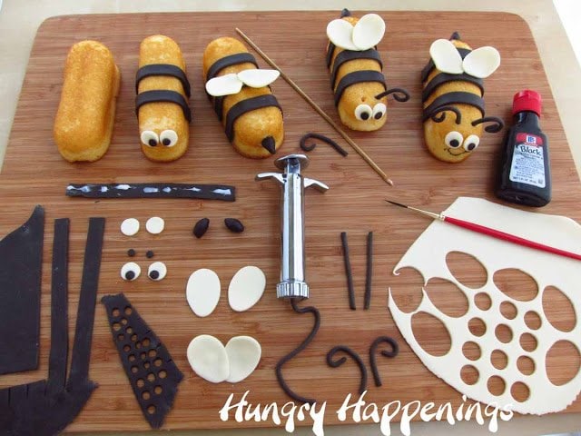 making Twinkie Bumble Bees decorated with modeling chocolate wings, stripes, eyes, and antennae.