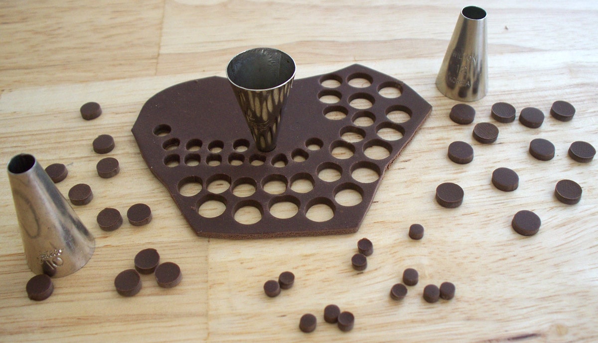 cutting circles out of modeling chocolate using round pastry tips. 