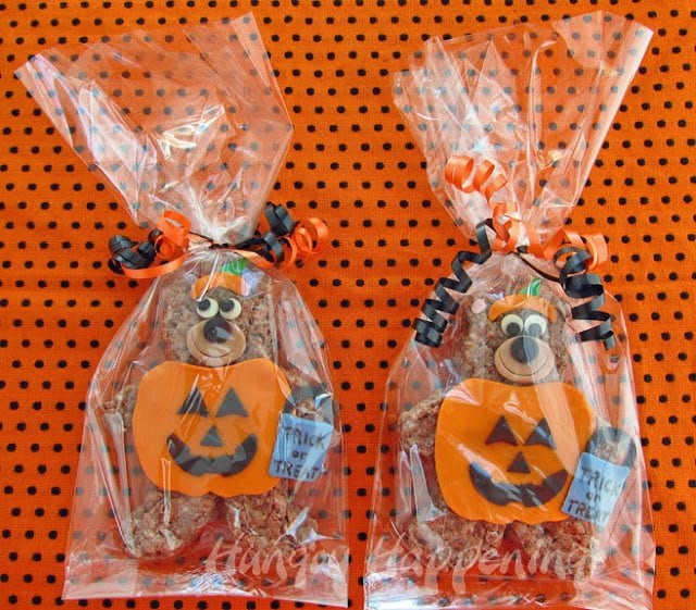 Cocoa Krispies Trick or Treat bears packaged in clear cellophane bags set on a orange and black polka dot towel. 