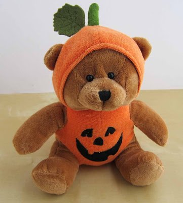 Halloween teddy bear in a pumpkin costume. 