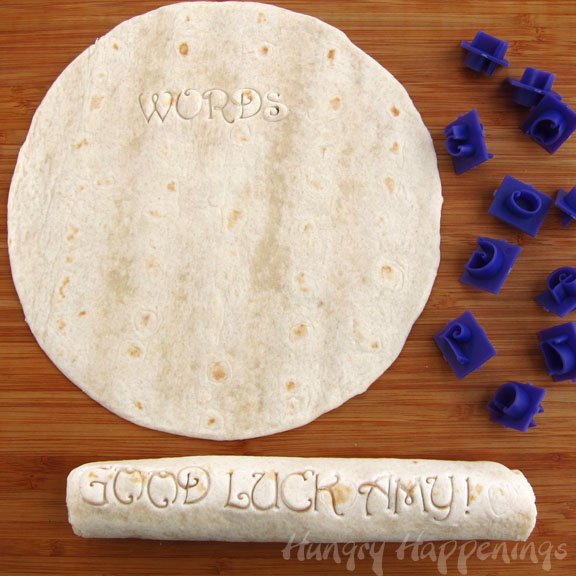 stamping a message into a tortilla using plastic alphabet garden stones.