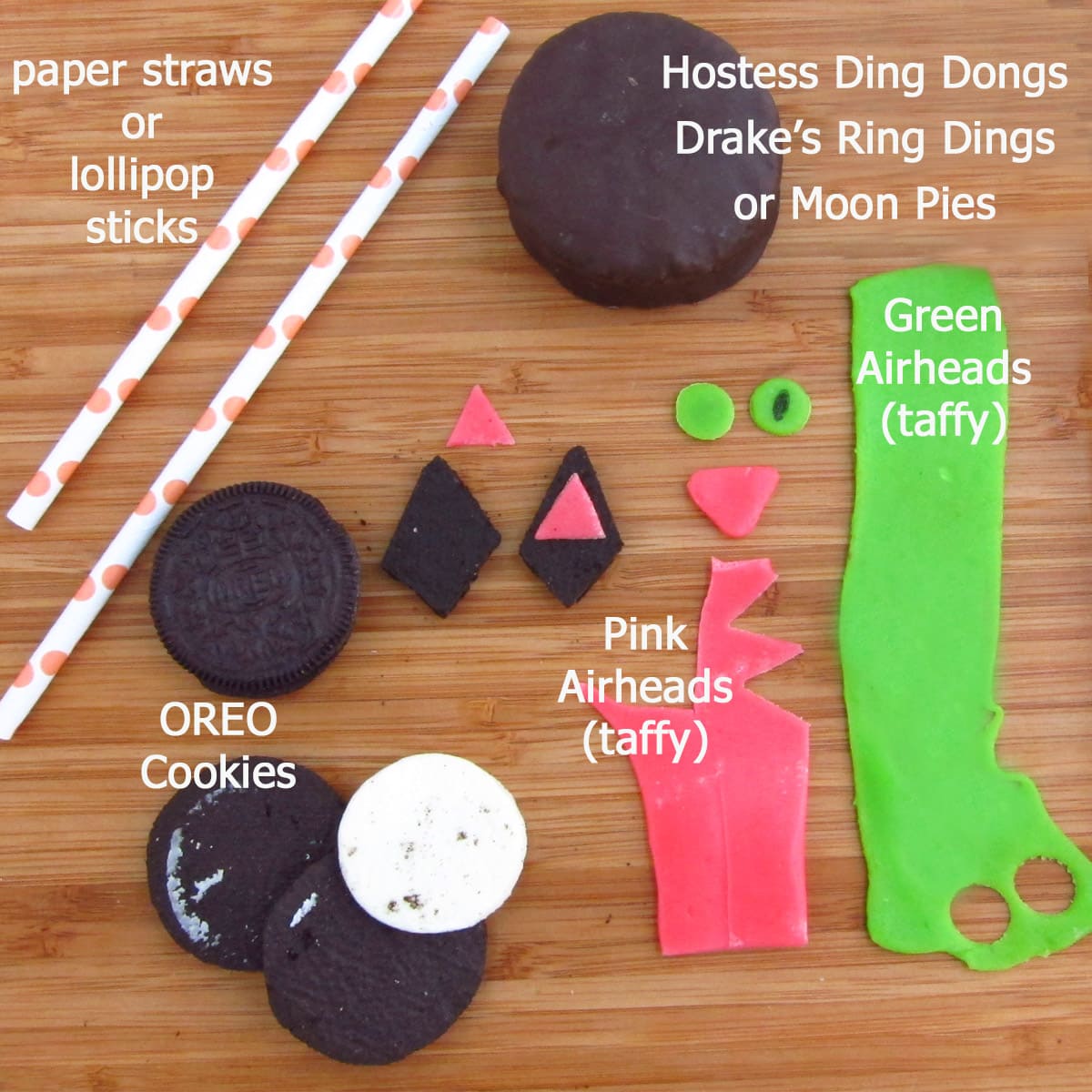 black cat cakes ingredients including chocolate snack cakes, OREO cookies, and pink & green AirHeads. 
