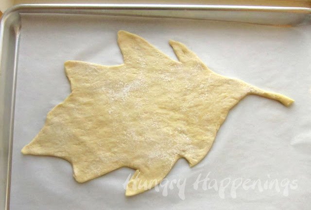 leaf shaped dough on a parchment paper-lined baking sheet. 