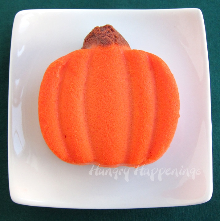 mini cheesecake pumpkin served on a small square white plate. 