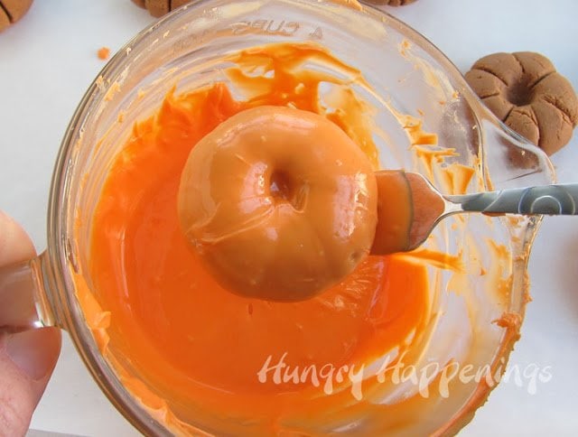 allowing the excess candy melts to drip off the chocolate pumpkins.
