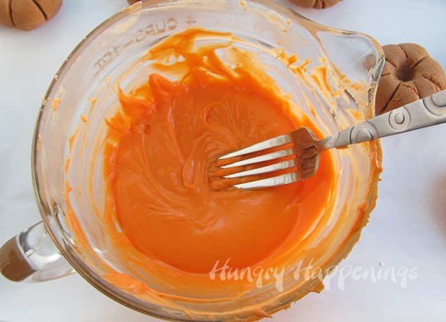 completely covering the fudge pumpkin in the orange candy melts. 