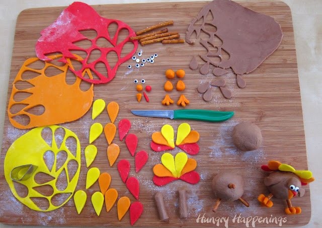 Fudge turkey modeling chocolate feathers, feet, beaks, and wattles plus pretzel sticks and candy eyes. 