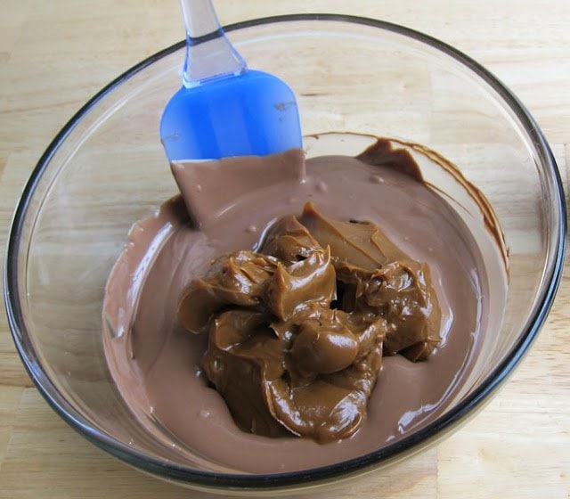 Stirring Dulce de Leche into a bowl of melted milk chocolate. 