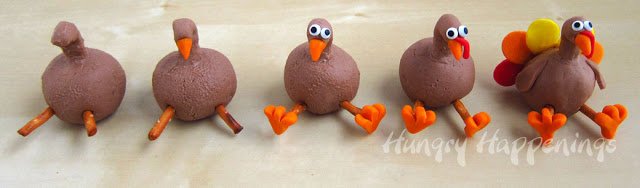 creating fudge turkeys with an orange beak, candy eyes, orange feet, a red wattle, and the colored tail feathers. 