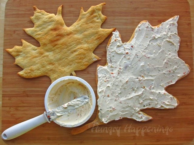 veggie cream cheese spread over one of the leaf-shaped crusts. 