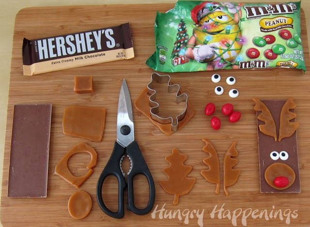 making Rudolph the Red Nose Reindeer candy bars using Hershey's Milk chocolate bars, peanut M&M's, caramel, and candy eyes. 