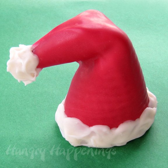 sugar cone decorated like a Santa hat using red and white candy melts. 