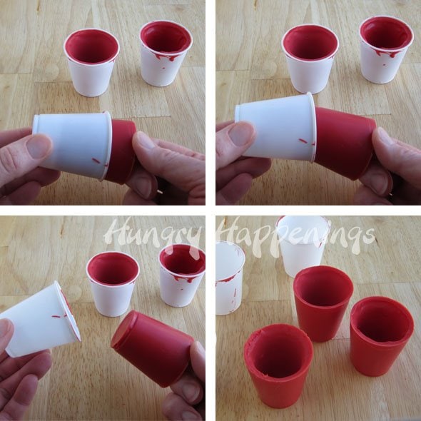 removing red candy cups from white plastic cup molds.
