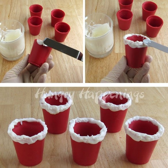adding a white furry band to the top of red candy Santa Suit Cups. 