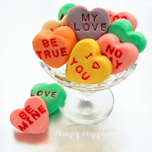 This Valentine's Day tell your loved ones how you feel by making colorful white chocolate Conversation Heart Fudge. Each bite sized candy can be imprinted with traditional conversation heart phrases or something more personal.