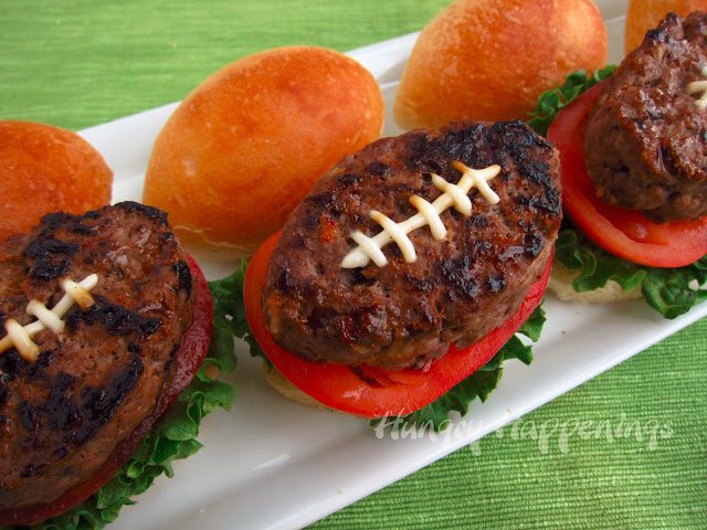 Super Bowl Hamburgers served on football-shaped hamburger buns with lettuce and tomato. 