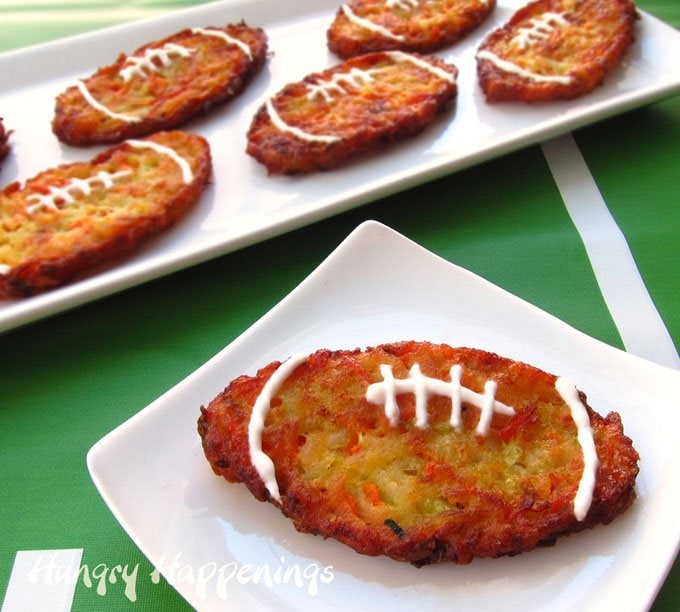 Zucchini fritters shaped like footballs decorated with Greek yogurt laces.