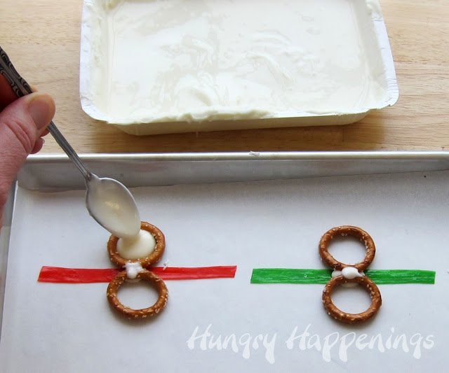 filling the top round pretzel with white chocolate. 
