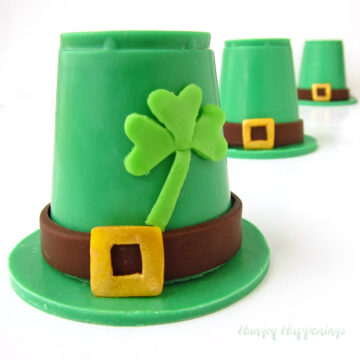 Chocolate Leprechaun Hats made from green candy melts decorated with modeling chocolate shamrocks