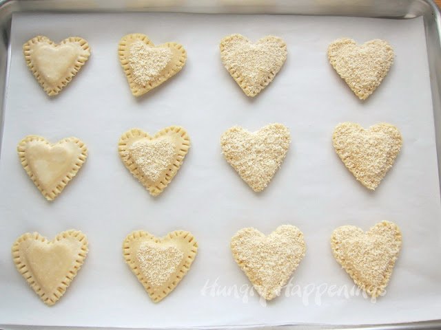 heart-shaped mozzarella cheese-filled pastries on a baking tray