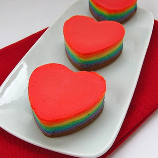 Add a rainbow of colors to to your Valentine's Day Desserts. These multi-colored Rainbow Cheesecake Hearts taste as great as they look.