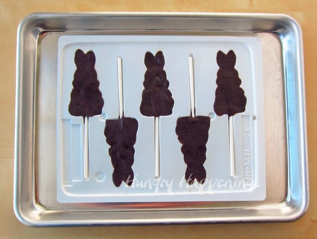 a hard candy bunny mold filled with chocolate cookie dough and lollipop sticks. 
