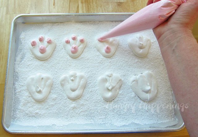 piping pink dots onto the bunny feet marshmallows. 