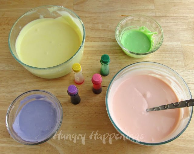 coloring cheesecake filling using yellow, green, pink, and purple food coloring. 