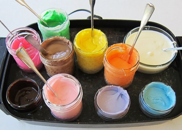 melting colored candy melts in jars and bowls set in a water batch in an electric skillet. 