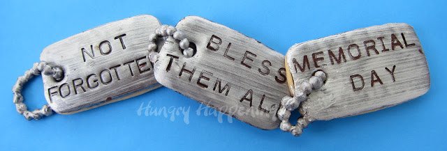 dog tag cookies that say, "not forgotten," "bless them all," and "Memorial Day".