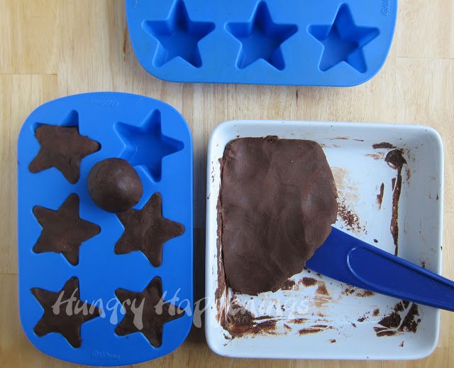 rolling chocolate fudge into a ball and then pressing it into silicone star molds. 