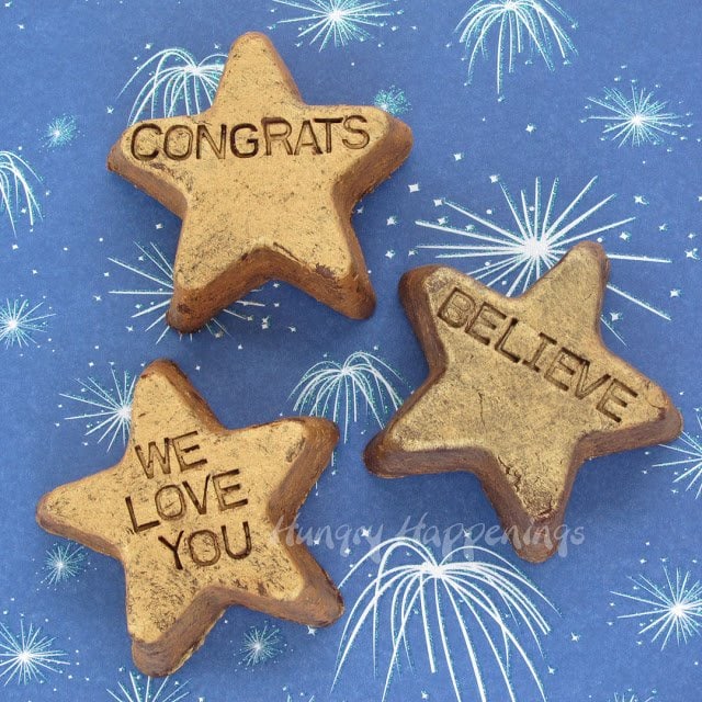 fudgy gold stars imprinted with "congrats," "believe," and "we love you"