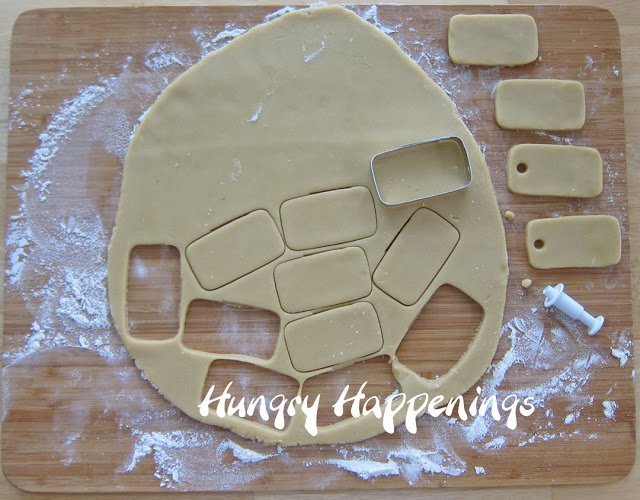 cutting out rectangle dog-tag cookies 