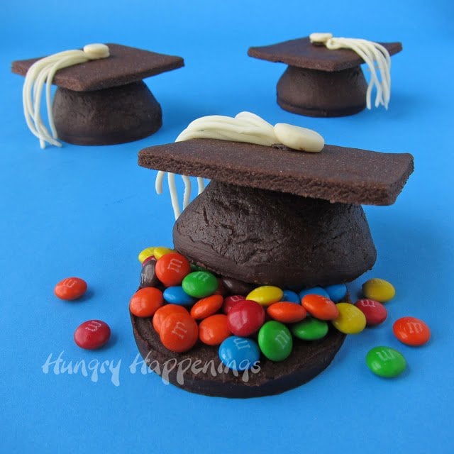 3-D chocolate graduation cookies with modeling chocolate tassels are filled with candies.