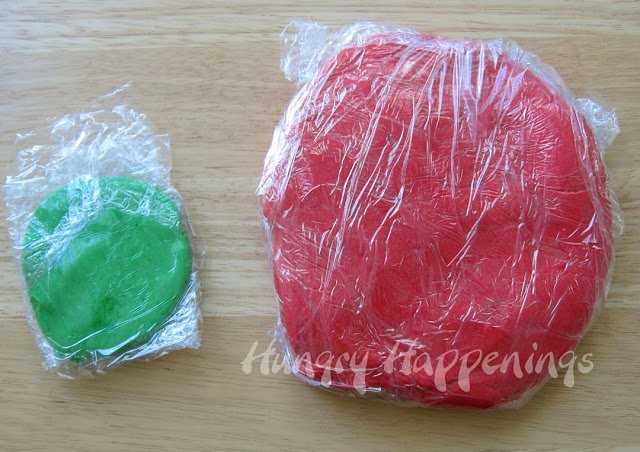 red and green strawberries and cream fudge wrapped in plastic wrap. 