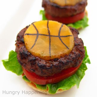 cheeseburgers topped with basketball cheese slices. 