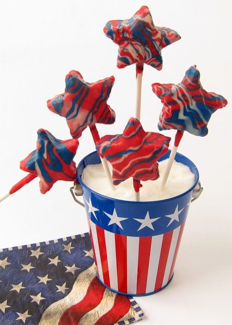 4th of July rice crispy treats stars arranged in a metal pail with stars and stripes.