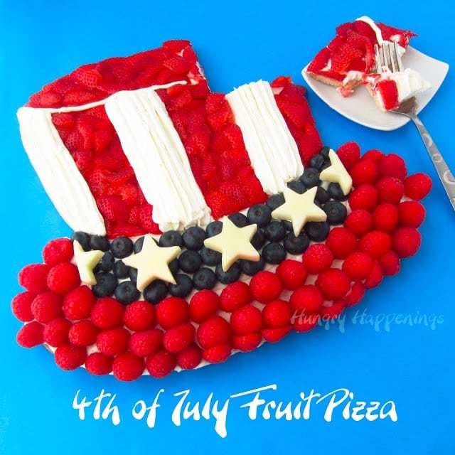 a piece cut out of a 4th of July fruit pizza Uncle Sam Hat dessert.