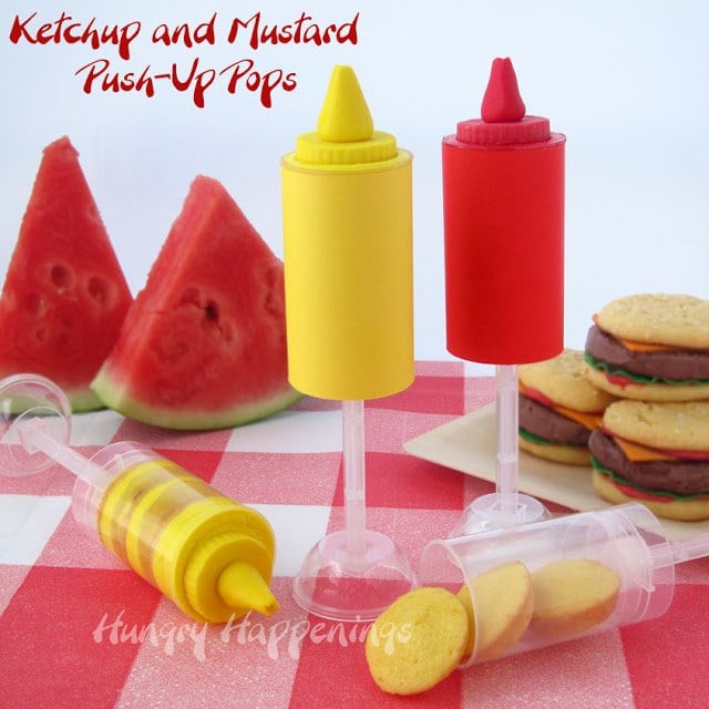 ketchup and mustard push-up pops with layers of cake and frosting with hamburger-shaped ice cream sandwiches and slices of watermelon.