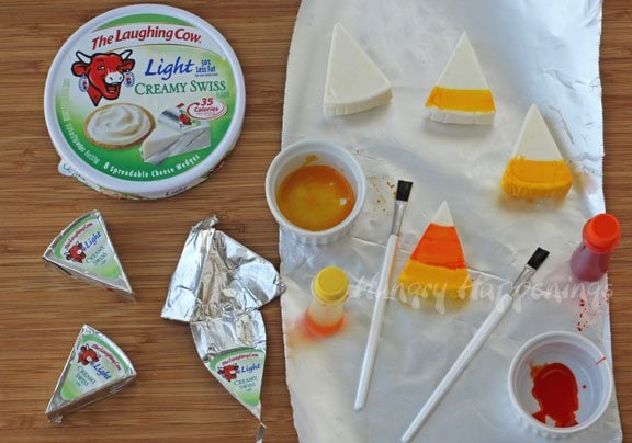 decorated Laughing Cow Light Creamy Swiss cheese wedges to look like candy corn using orange and yellow food coloring. 
