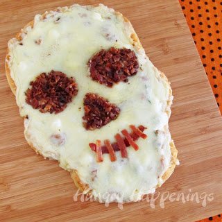 Skull shaped pizza topped with crispy bacon