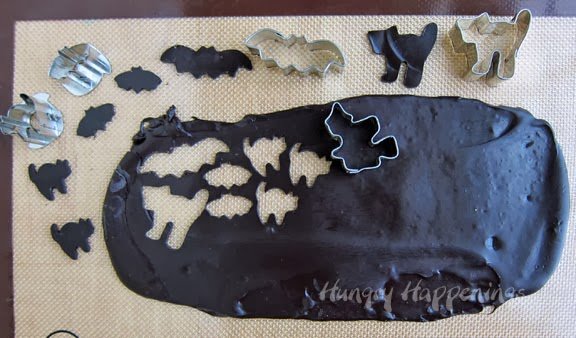 cutting out black cheese cats, bats, and witches. 