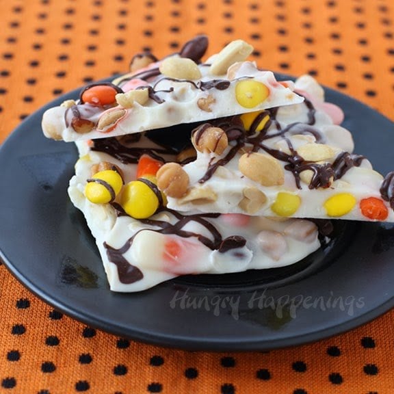 Halloween candy corn bark loaded with peanuts, caramel, candy corn, and Reese's Pieces. 