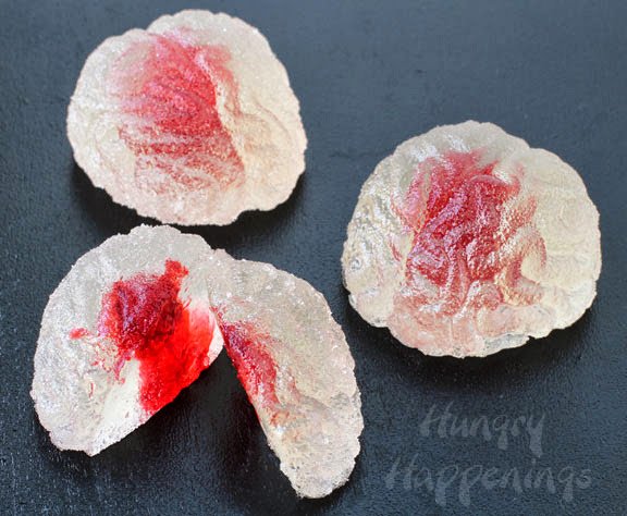 Brain-shaped gumdrops with red food coloring "blood" inside. 