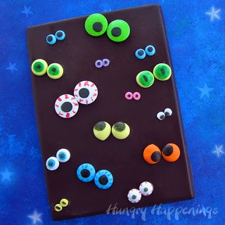 dark chocolate candy bar with lots of candy eyes. 
