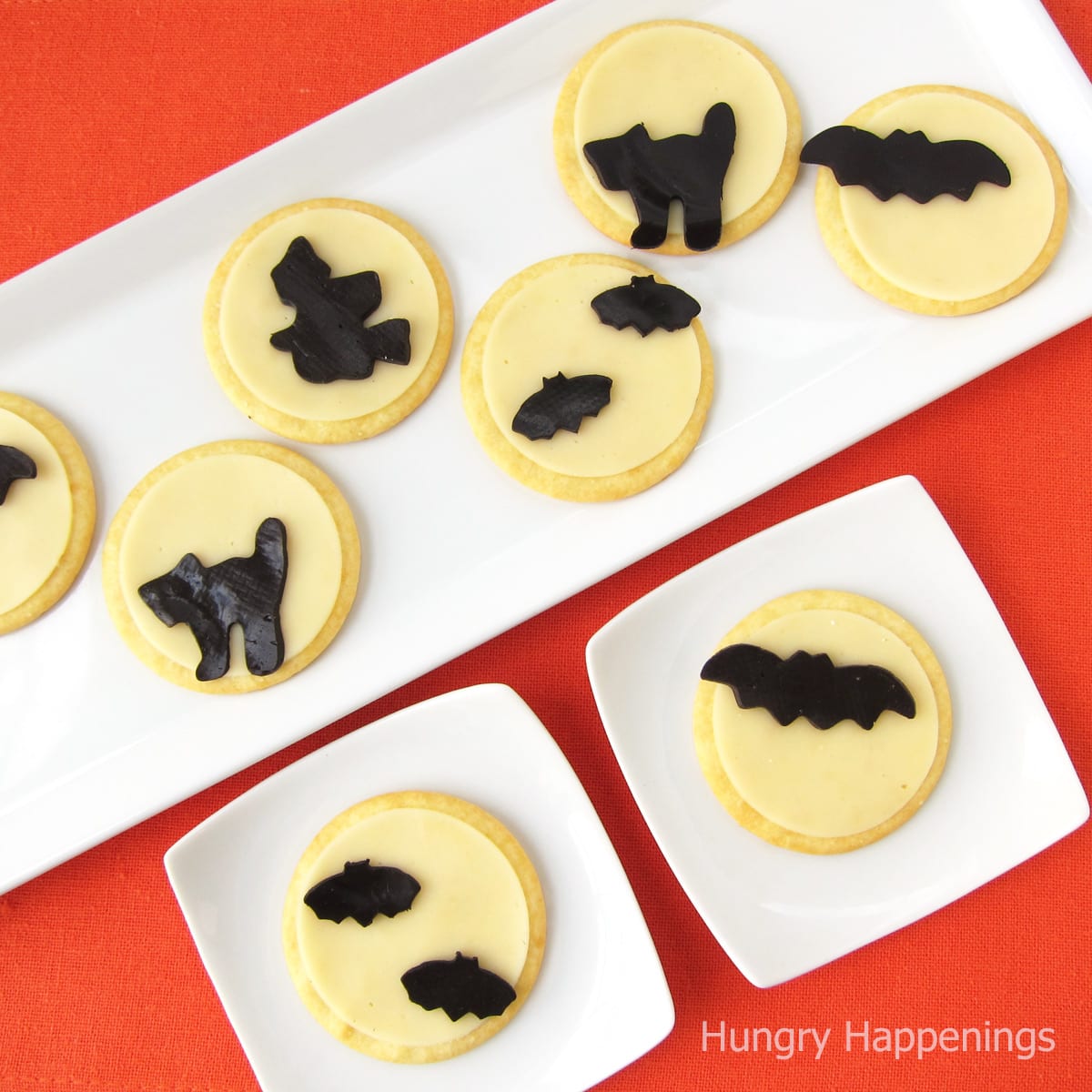 crackers topped with white cheese moons and black cheese bats, cats, and witches.